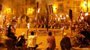 a group of people sitting around with torches and flags at Apartamento vacacional in El Pont de Suert