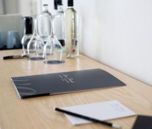 a desk with aepad and glasses and a pen at Hotel Lava Beach in Puerto del Carmen