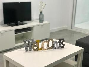 a white coffee table in a living room with a tv at Casa en CARABAÑA a 30 minutos de MADRID in Carabaña