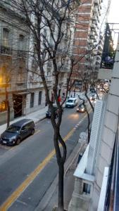 a tree on the side of a city street at Ex Loi Suites Arenales in Buenos Aires