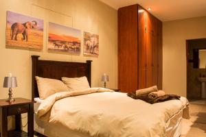 a bedroom with a large bed and posters on the wall at Sea View Bliss Guesthouse with self Catering in Swakopmund +47 photos