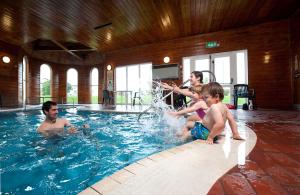 a group of people playing in a swimming pool at Perran View Holiday Park in St. Agnes