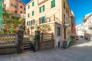 a building with a gate and stairs on a street at Il Giardino di Riomaggiore Suite in Riomaggiore