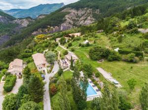 an estate in the mountains with a swimming pool at Ferme Fortia in Montréal-les-Sources