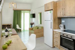 a kitchen and living room with a table and chairs at Castell Hotel in Kissamos