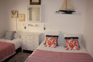 a bedroom with two beds and a dresser and a mirror at Seastar in Vilamoura +23 photos
