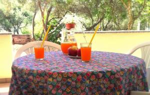 a table with two glasses of orange juice on it at Apartments Olea in Pinezici +39 photos