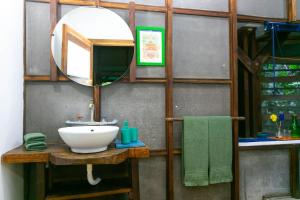 
a bathroom with a sink and a mirror at La Kukula Lodge in Puerto Viejo

