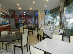 a dining room with tables and chairs in a restaurant at City Residence Rama 6 in Bangkok +8 photos