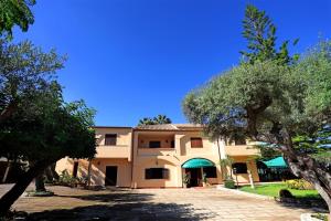 a large building with trees in front of it at La Perciata in Contrada Maeggio