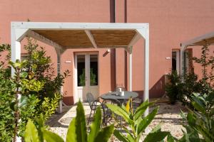 a patio with a table and chairs in front of a building at Masseria Mongiò dell'Elefante in Otranto