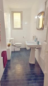 a white bathroom with a sink and a toilet at Central Apartment in Valencia with WIFI + Parking. in Valencia