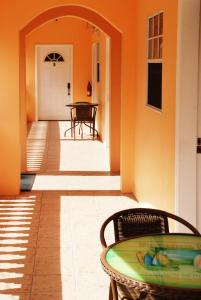 a porch with a table and a door with a table at Aupic Paradise in Vieux Fort