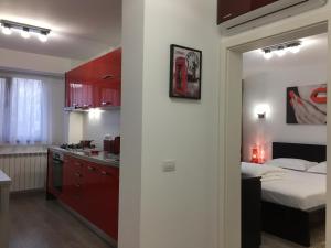 a kitchen and a bedroom with a bed and a counter at Luxury Apartment in Galaţi