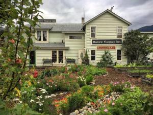 a house with a flower garden in front of it at Historic Skagway Inn in Skagway