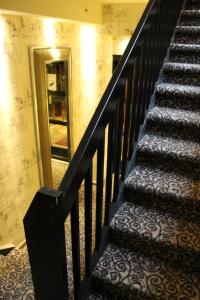 
a stairway leading up to a stairway with stairs at Det Hanseatiske Hotel in Bergen
