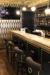 a bar with chairs and a counter in a restaurant at Det Hanseatiske Hotel in Bergen