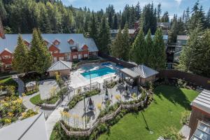 an aerial view of a house with a pool and a yard at Lake Placid Lodge by Whiski Jack in Whistler