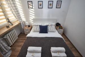 Posteľ alebo postele v izbe v ubytovaní Noctis Apartment Pańska II