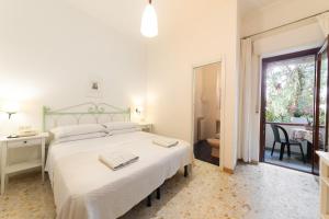 a bedroom with a large bed and a bathroom at Hotel Europa in Ischia