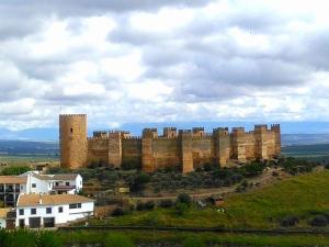 a large castle on top of a hill at Posada El Majuelo in Baños de la Encina