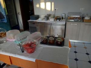 a kitchen with a table with jars of food on it at Katerina Lefkada in Vasiliki