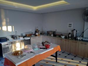 a kitchen with a table with food on it at Katerina Lefkada in Vasiliki