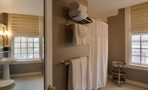 a bathroom with a towel hanging on the wall at Sentinel, a Provenance Hotel in Portland