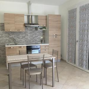 a kitchen with a table and chairs in a room at Casa Vacanze Le Casette in Masera