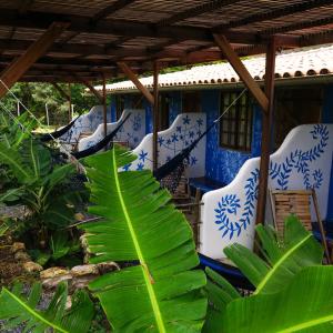 a group of blue and white chairs and plants at Terra de Aruanda pousada in Palmeiras