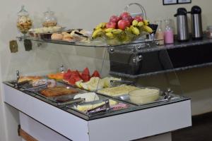 a buffet with many different types of food on it at Diplomata Hotel in Sertãozinho