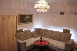 a living room with a couch and a chandelier at Domcek na orave in Habovka