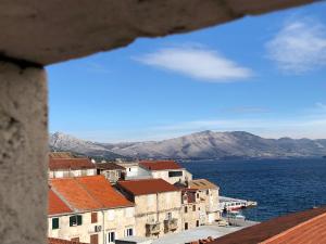 a view of a town with the water and mountains at Guest House Dijana in Korčula