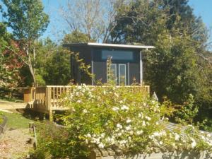 a tiny house in the middle of a garden at starry nights tree house in Waikino