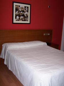 Postel nebo postele na pokoji v ubytování Hotel El Castillo