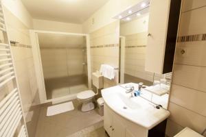 a white bathroom with a sink and a toilet at B&B Villa Ana in Krk