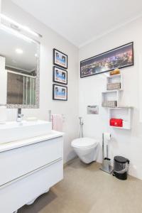 a white bathroom with a sink and a toilet at Cozy place in Lisbon 23 in Lisbon +18 photos