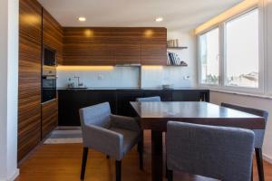 a kitchen with a table and chairs in a room at Cozy place in Lisbon 23 in Lisbon