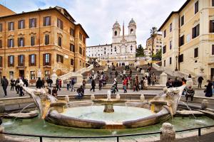 a group of people walking around a fountain in a city at Flaminia 36 Luxury Home in Rome