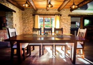 a dining room with a wooden table and chairs at La Mora Casa de Campo in Huasca de Ocampo