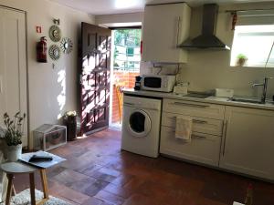 a kitchen with a washing machine and a stove at Studio & Garden in Lisbon