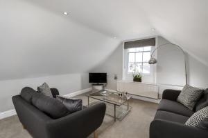 a living room with two couches and a table at Gorgeous Apartment in the centre of Winchester in Winchester +2 photos