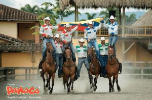 a group of men riding horses in a rodeo at Fincas Panaca Herreria 26 in Quimbaya