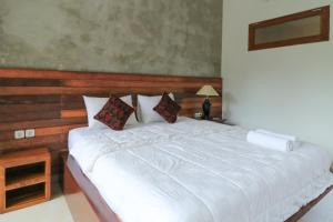 Postel nebo postele na pokoji v ubytování Yuliati House Ubud
