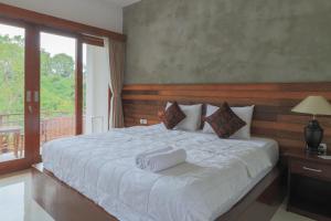 Postel nebo postele na pokoji v ubytování Yuliati House Ubud