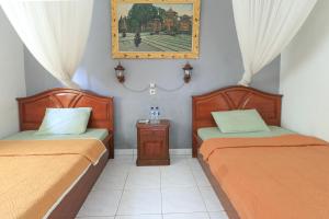 Postel nebo postele na pokoji v ubytování Yuliati House Ubud