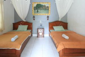 Postel nebo postele na pokoji v ubytování Yuliati House Ubud