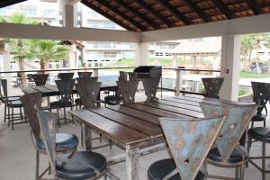 a wooden table and chairs on a patio at Corona Del Sol 1104, Puerto Peñasco, Las Conchas in Puerto Peñasco