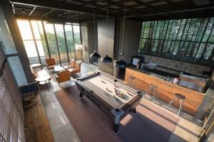a large living room with a pool table in it at Inchantreedoopool in Kanchanaburi City