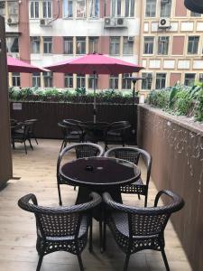 a patio table with chairs and umbrellas at Harbour Bay Hotel in Hong Kong